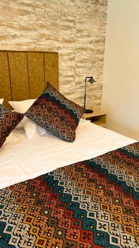 a bed with two pillows on top of it at Casa Turística Don Juan in Ibagué