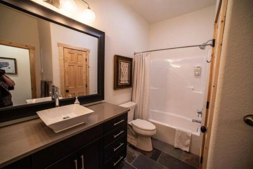 a bathroom with a sink and a toilet and a mirror at Little Hope Chalet At Terry Peak Ski Resort in Lead