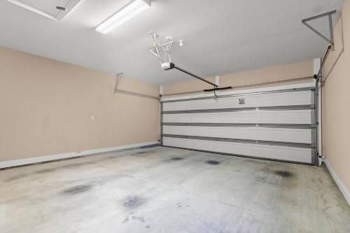 an empty garage with a metal garage door at Contractor-readypets Ok 2 Kings Fast Wifi in Lake Charles