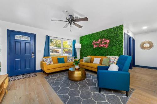 a living room with yellow couches and a blue door at Pets Ok! Heated Pool Mins To 3 Sisters Spring! in Crystal River