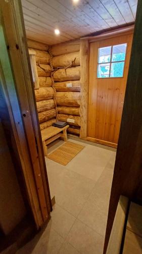 a room in a log cabin with a bench in it at Tammiku saunamaja 