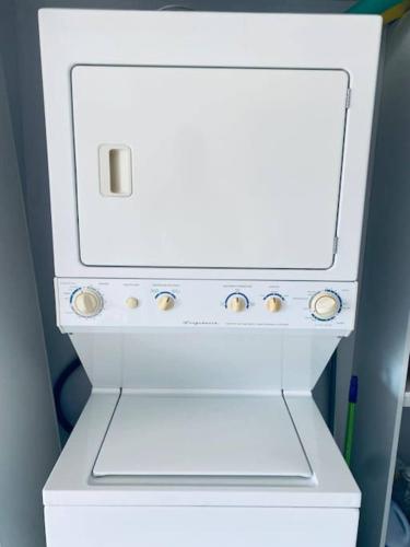 a white stove top oven sitting in a room at Stunning 9th Flr Pacific Ocean And Mtn View in Jacó