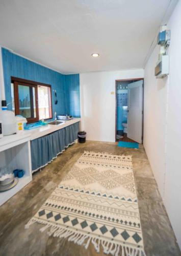 a kitchen with blue and white walls and a counter at Sunset Dream Beach Front House in Thong Sala