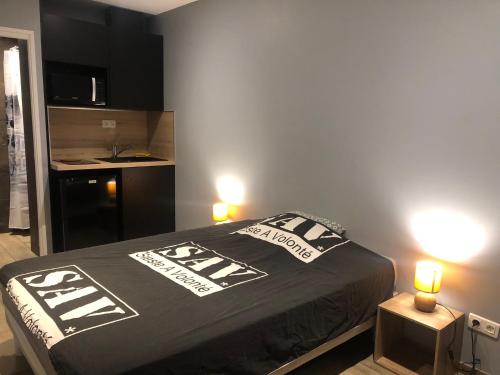 - une chambre dotée d'un lit avec deux lumières dans l'établissement Mini Studio avec Terrasse, à Aurillac