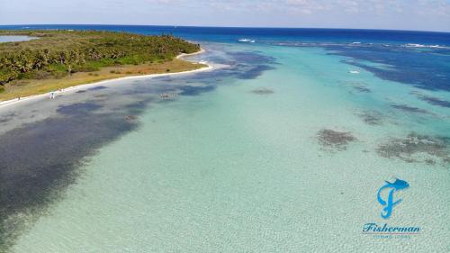 an aerial view of a beach and the ocean at Casa Paraiso Punta Allen in Punta Allen