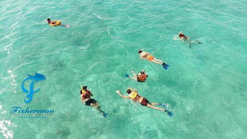 a group of people swimming in the water at Casa Paraiso Punta Allen in Punta Allen