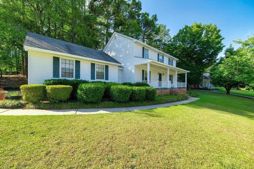 a white house with bushes in a yard at Cozy 3BR Home Peaceful Vibes Centrally Located in Martinez