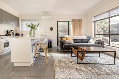 a kitchen and living room with a couch and a table at Golden Retreat - Couples Getaway Business stay in Golden Square