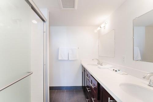 a white bathroom with two sinks and a mirror at Coastal Escape - Pool - Beach in Boca Raton