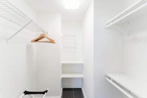 a room with white walls and a white closet at Coastal Escape - Pool - Beach in Boca Raton