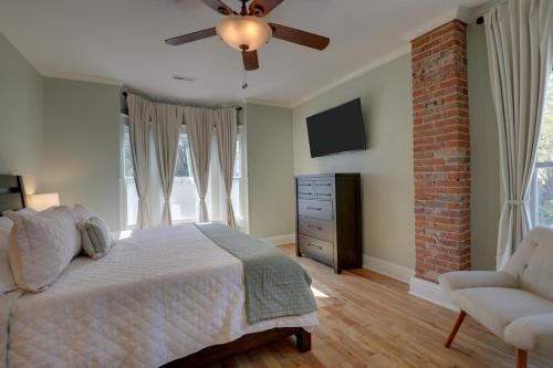a bedroom with a bed and a ceiling fan at Charming Escape - Private Hot Tub! in Hannibal