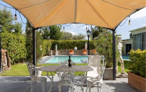 a table and chairs under an umbrella next to a pool at Prato Bello in Fucecchio