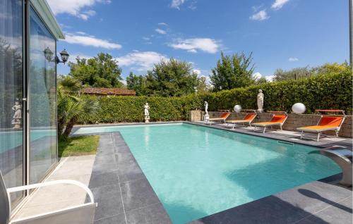 a swimming pool with chairs and a house at Prato Bello in Fucecchio