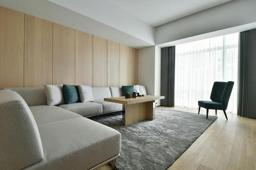 a living room with a couch and a table at THE AMNIS, a Luxury Collection Hotel, Kaohsiung in Kaohsiung