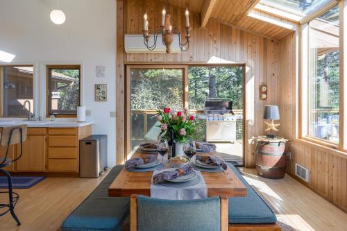 a kitchen and dining room with a table with flowers on it at Waterfront Privacy, Pet-friendly, Close To Trails in Olga