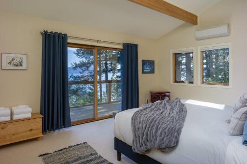 a bedroom with a bed and a large window at Waterfront Privacy, Pet-friendly, Close To Trails in Olga