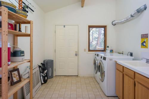 a kitchen with a washing machine and a sink at Waterfront Privacy, Pet-friendly, Close To Trails in Olga