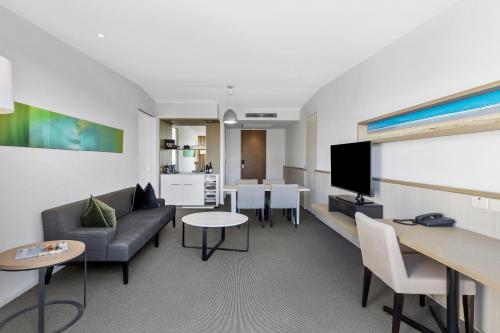 a living room with a couch and a table at Quarters at Flinders Hotel in Flinders