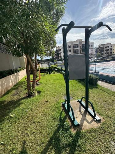 a sign in the grass next to a tree at Luxurious and comfortable 1 level in Juan López