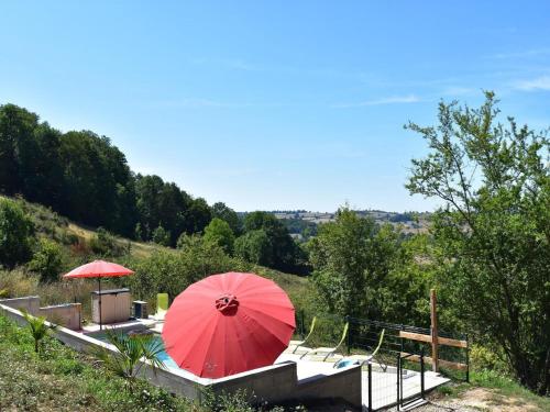 a red umbrella sitting on top of a table at Apartment in Cuzy with Heated Pool in Cuzy
