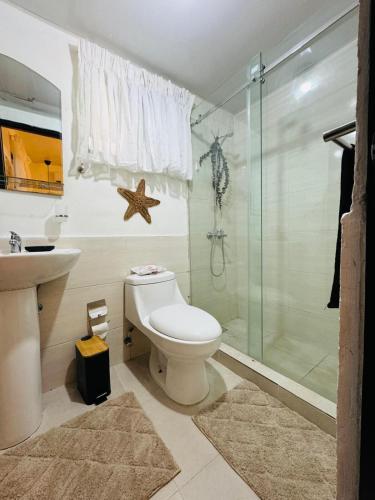 a bathroom with a toilet and a glass shower at Luxurious and comfortable 1 level in Juan López