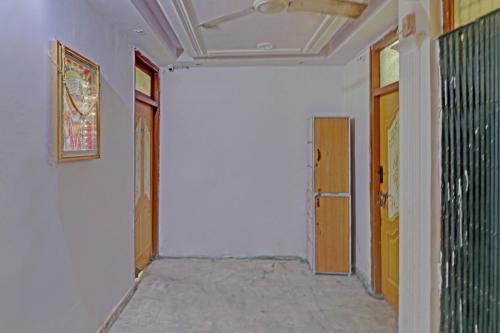 an empty room with a hallway with two doors at Hotel O by OYO Happy Homes in New Delhi