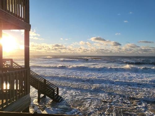 a view of the ocean from the porch of a beach house at Beachfront Bungalow 124 in North Topsail Beach