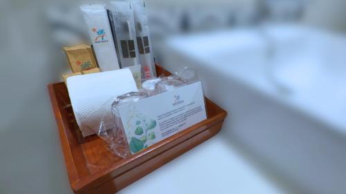 a wooden shelf with a box of tissues and books at Whiterock Beach Hotel and Waterpark in Subic