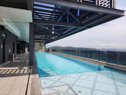 a swimming pool on the roof of a building at Mossaz minimalist studio 3 in Petaling Jaya
