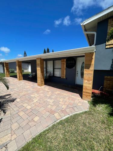 a house with a brick driveway in front of it at Kiss The Wave - Spacious 4br3ba, Wpoolhot Tub in Indian Harbour Beach