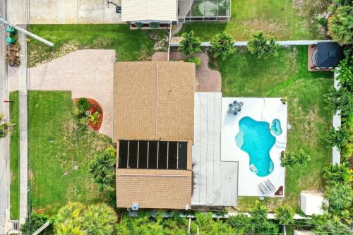 an overhead view of a house with a solar panel on the yard at Kiss The Wave - Spacious 4br3ba, Wpoolhot Tub in Indian Harbour Beach
