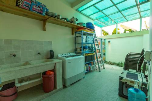 a kitchen with a stove and a sink in a room at Villa Alida Nagua Pool Beach Dailymaid & Bbq in Matancita