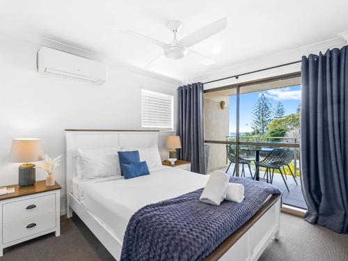 a bedroom with a bed and a balcony at Beachside Views 2 Bedroom Apartments Mooloolaba in Mooloolaba