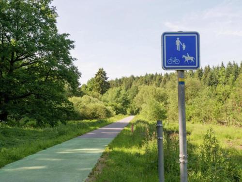 a blue sign on the side of a road at Cozy Forest Chalet in Ovifat in Ovifat