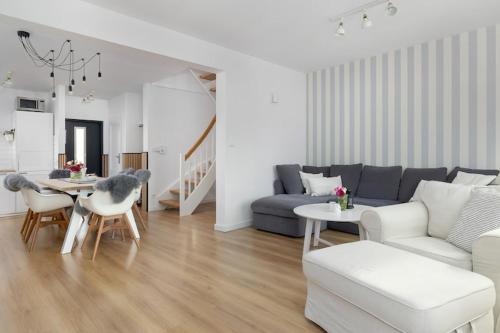 a living room with a couch and a table at Holiday home, 3 bedrooms, private garden in Trzęsacz