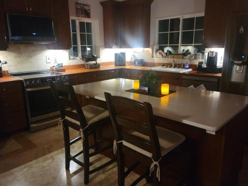 a kitchen with a table and two chairs in it at Oceanfront Resort-Style Oasis -Private Pool & Car in Grand Turk