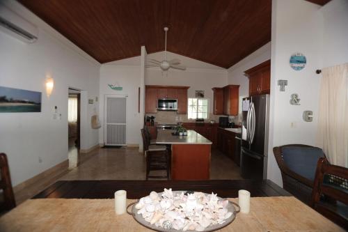 a kitchen and living room with a table and a kitchen at Oceanfront Resort-Style Oasis -Private Pool & Car in Grand Turk