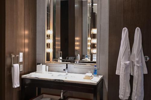 a bathroom with a sink and a large mirror at Park Hyatt Shanghai in Shanghai