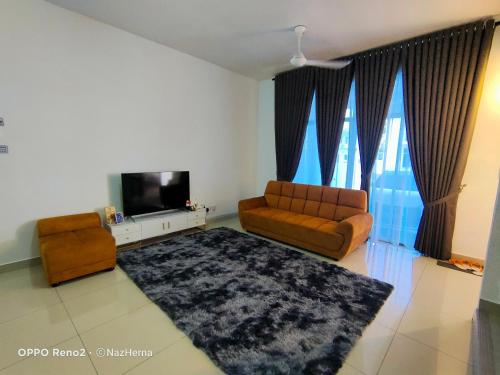 a living room with a couch and a television at NH Stay, Parit Buntar Perak in Parit Buntar
