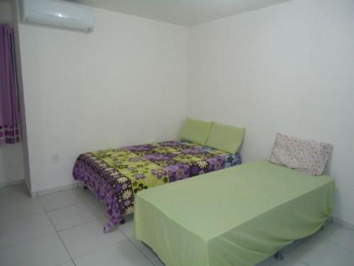 Ένα ή περισσότερα κρεβάτια σε δωμάτιο στο Casa em Condomínio na Praia de Pirangi RN