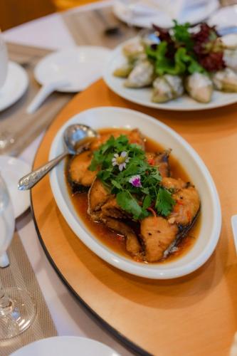 a white plate of food on a table at Lailaresidence in Yala