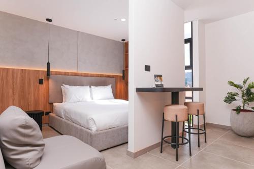 a bedroom with a bed and a table and a chair at Metropolitan Living by HOUSY in Medellín