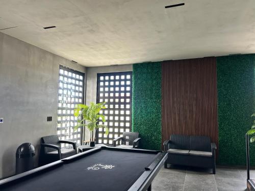 a pool table in a room with green walls at Habitación 4 in Rosarito Beach