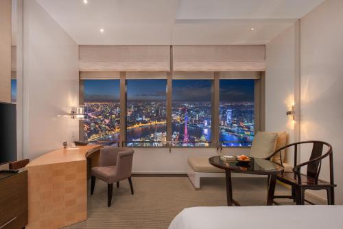 a hotel room with a view of a city at Park Hyatt Shanghai in Shanghai