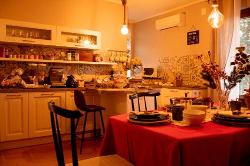 a kitchen with a table with a red table cloth at The Oaks in Spigno Saturnia