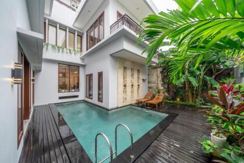 a swimming pool in the middle of a house at Modern 5BR Luxury Villa with Pool & Rooftop - 100m from Sanur Beach in Sanur