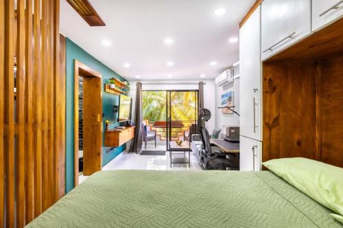 a bedroom with a green bed and a desk at nNomad Studio mins from Sirena - Apartment in Sosua