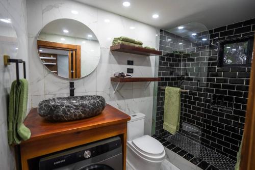 a bathroom with a sink and a toilet and a mirror at nNomad Studio mins from Sirena - Apartment in Sosua