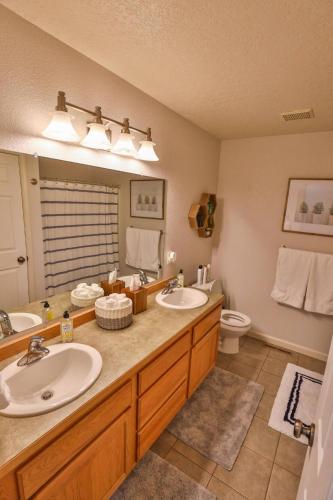 a bathroom with two sinks and a toilet at Peaceful Retreat in the Heart of Missoula in Missoula