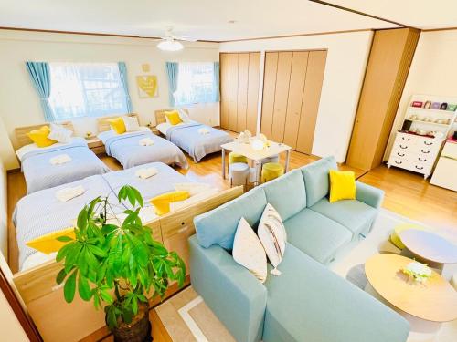 a living room with a blue couch and tables at ArudenaiDay in Tokushima